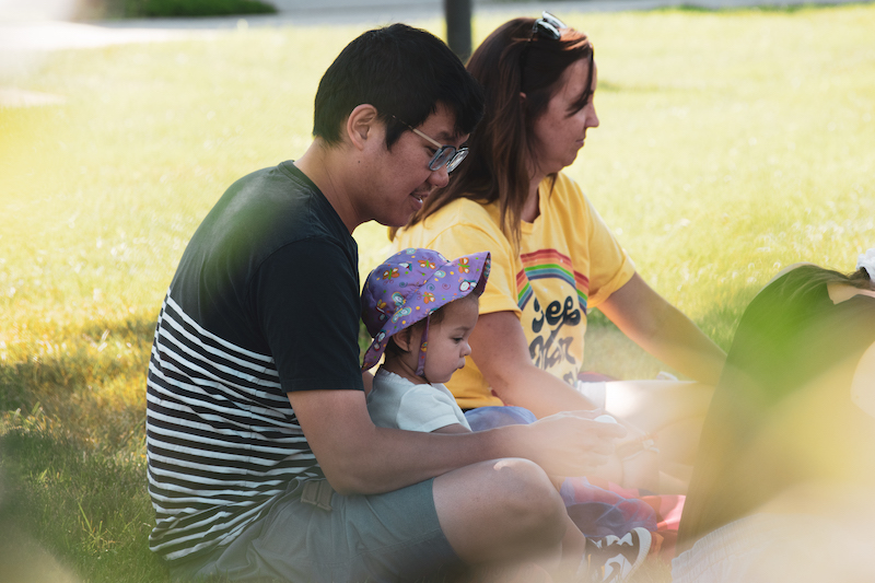 Dad and child sitting in a music class